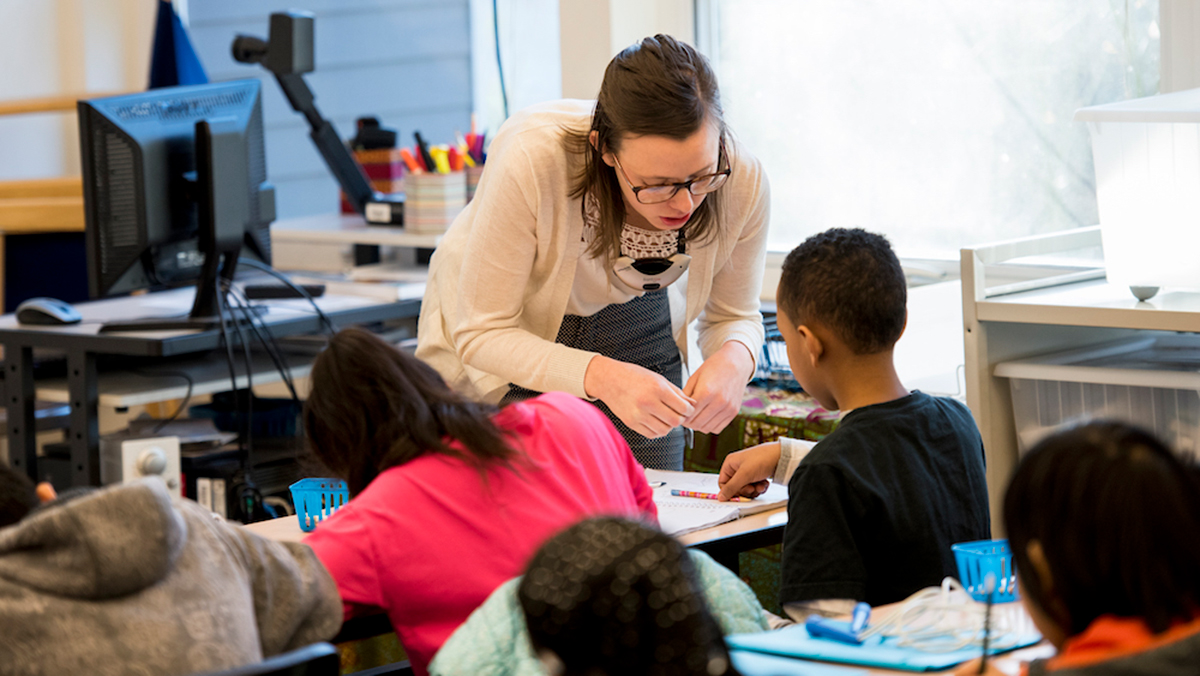 Teacher working with elementary students