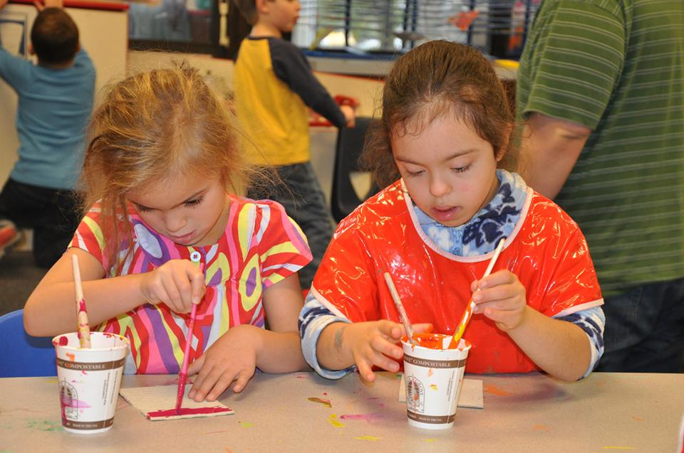 Two early childhood students working on an arts project