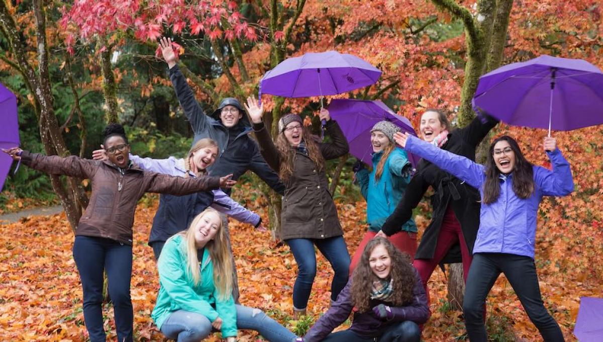 UW students holding purpose umbrellas