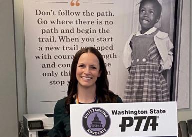 Cathi Davis holding a PTA award